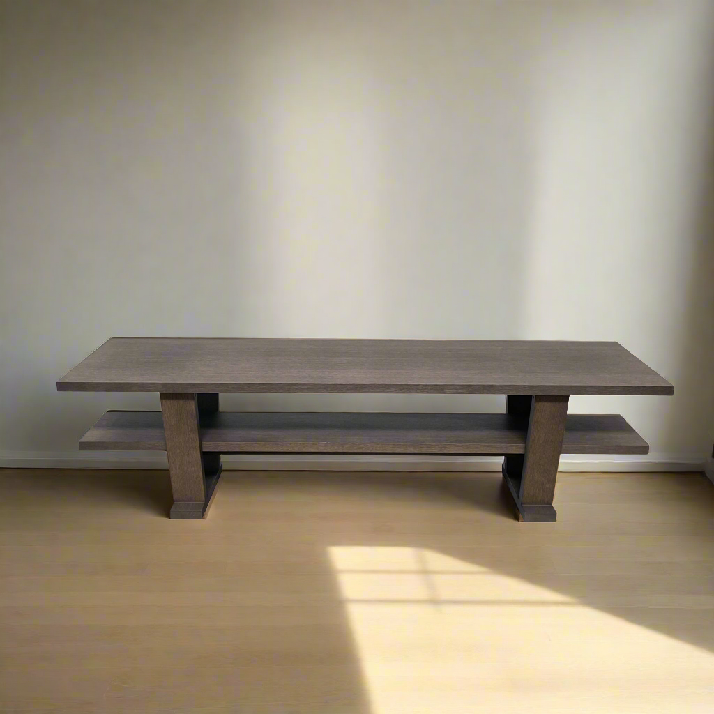 A wooden rectangular coffee table with a lower shelf and two supporting legs, reminiscent of a refined Maxalto Cicero Console by Maxalto.