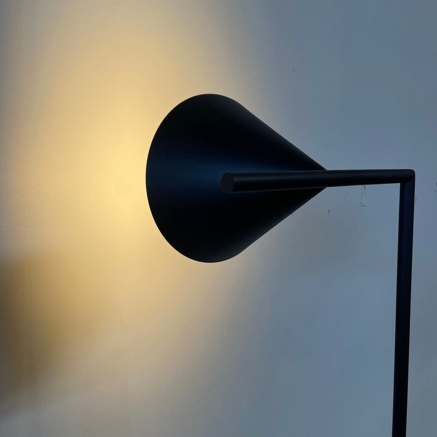 A Flos Captain Flint Floor Lamp with a conical shade, a round base, and a power cord with a foot switch on a plain white background.
