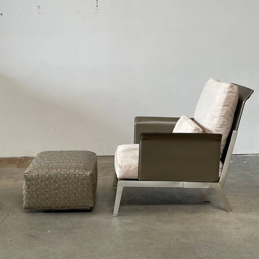 A Flexform Happy-Hour Lounge Chair with a gray cushioned seat, black metal frame, and angled legs is shown against a white background.