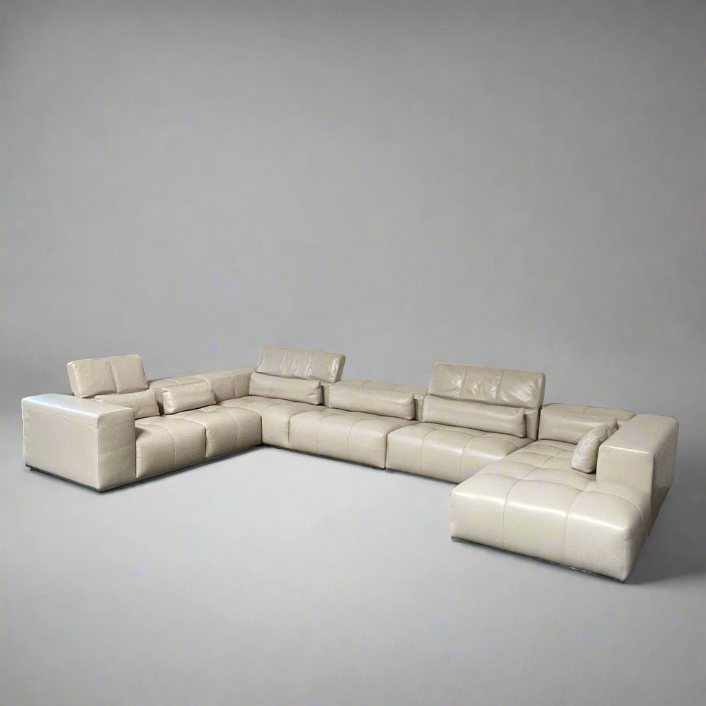 A large beige L-shaped Functions Nick Sectional sofa from the Functions brand, featuring cushioned seats and backs, is viewed against a plain white background.