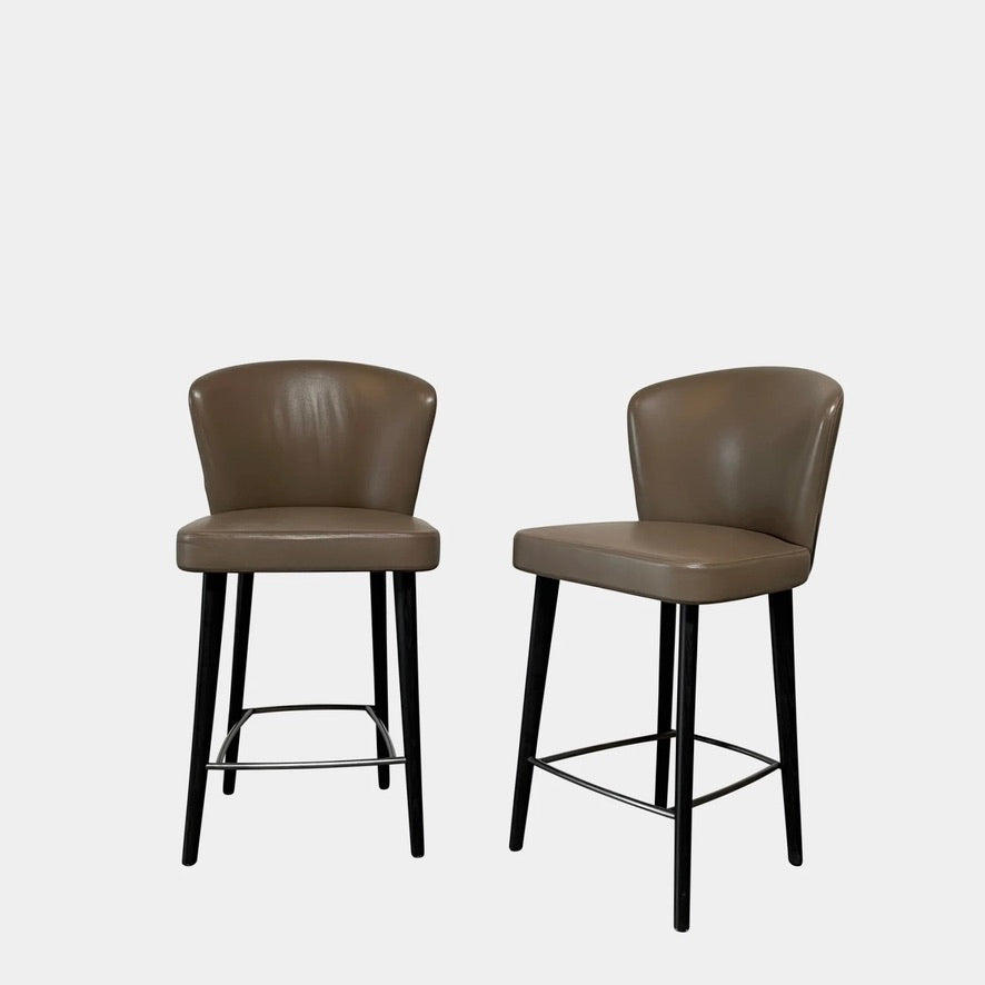 Two Minotti Aston Counter Stool Sets in Dark Taupe, featuring dark taupe leather cushioned seats and curved backs with black legs, are set against a plain white background.