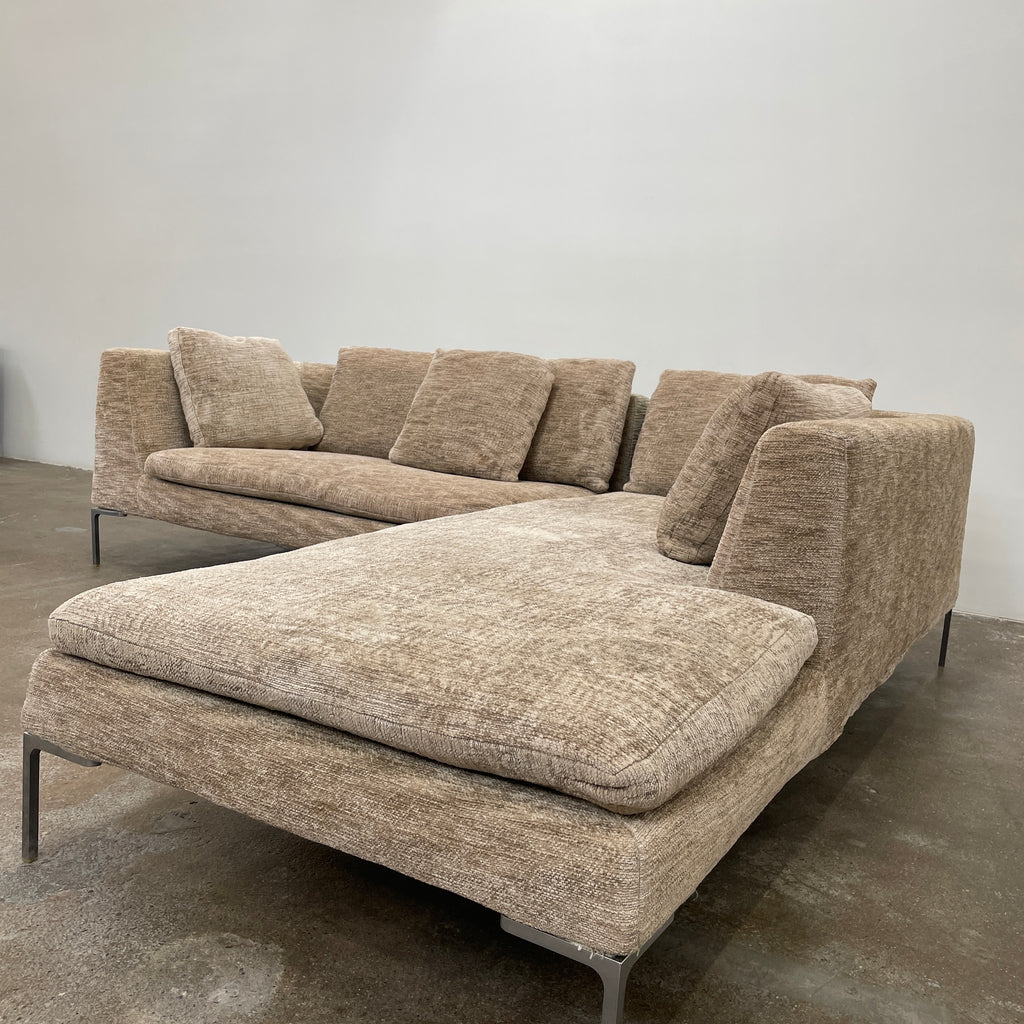 Introducing the B&B Italia Charles Sectional by Modern Resale: This beige L-shaped sectional sofa features textured fabric and stylish thin black metal legs. Set against a plain white background, it embodies modern elegance and timeless design.