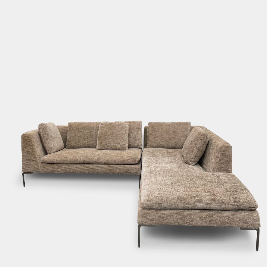 Introducing the B&B Italia Charles Sectional by Modern Resale: This beige L-shaped sectional sofa features textured fabric and stylish thin black metal legs. Set against a plain white background, it embodies modern elegance and timeless design.