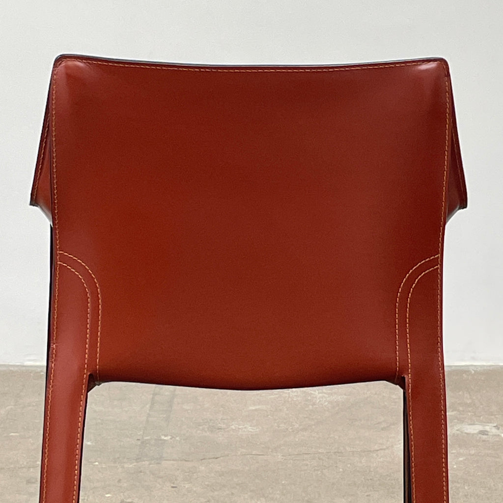 The Cassina Cab 413 Armchair in vibrant red leather presents a modern design with a high back and square legs, elegantly displayed against a plain white background.