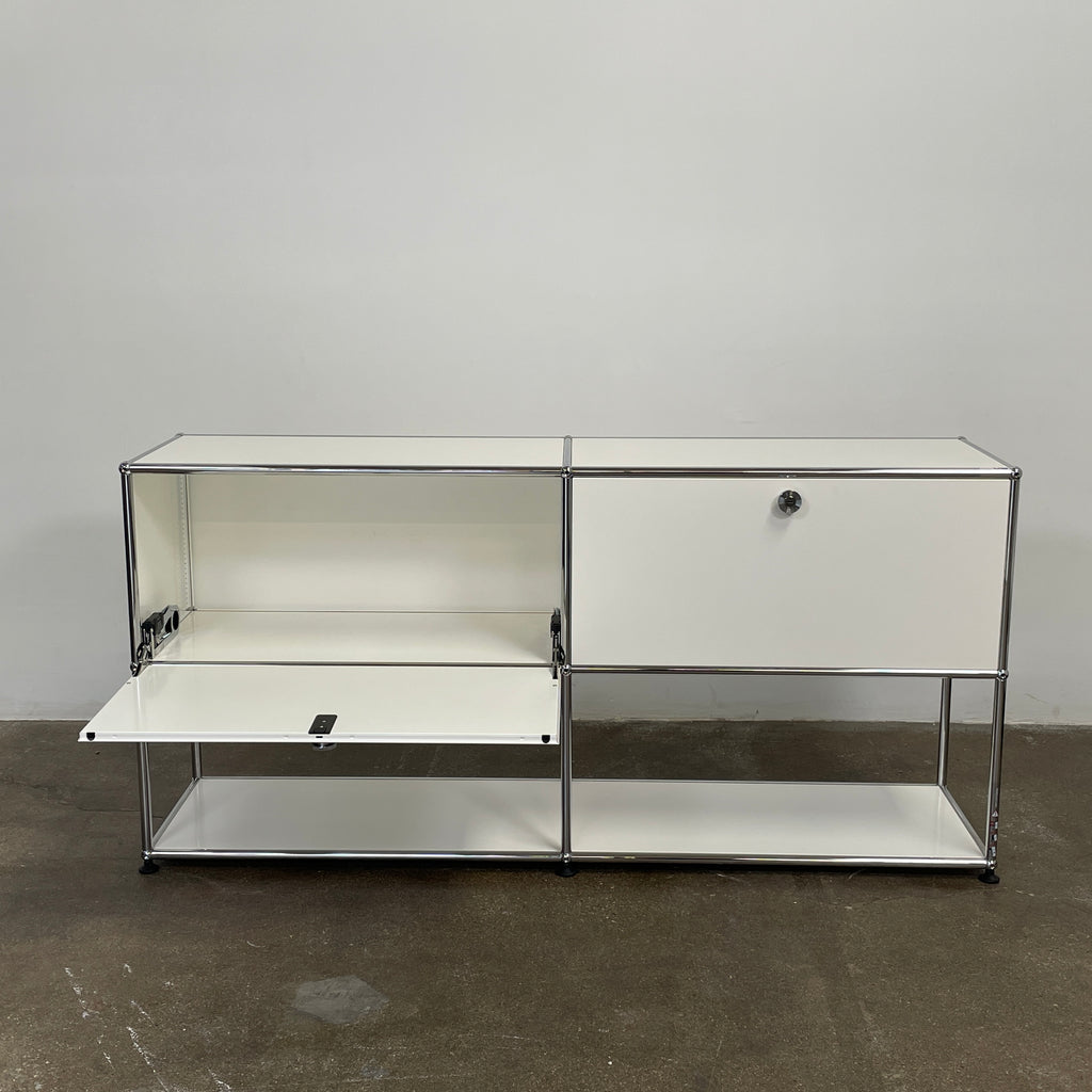 The modern USM Haller Open Credenza in white showcases two compartments with round metal handles and an open lower shelf for display, effortlessly combining functionality with contemporary design.