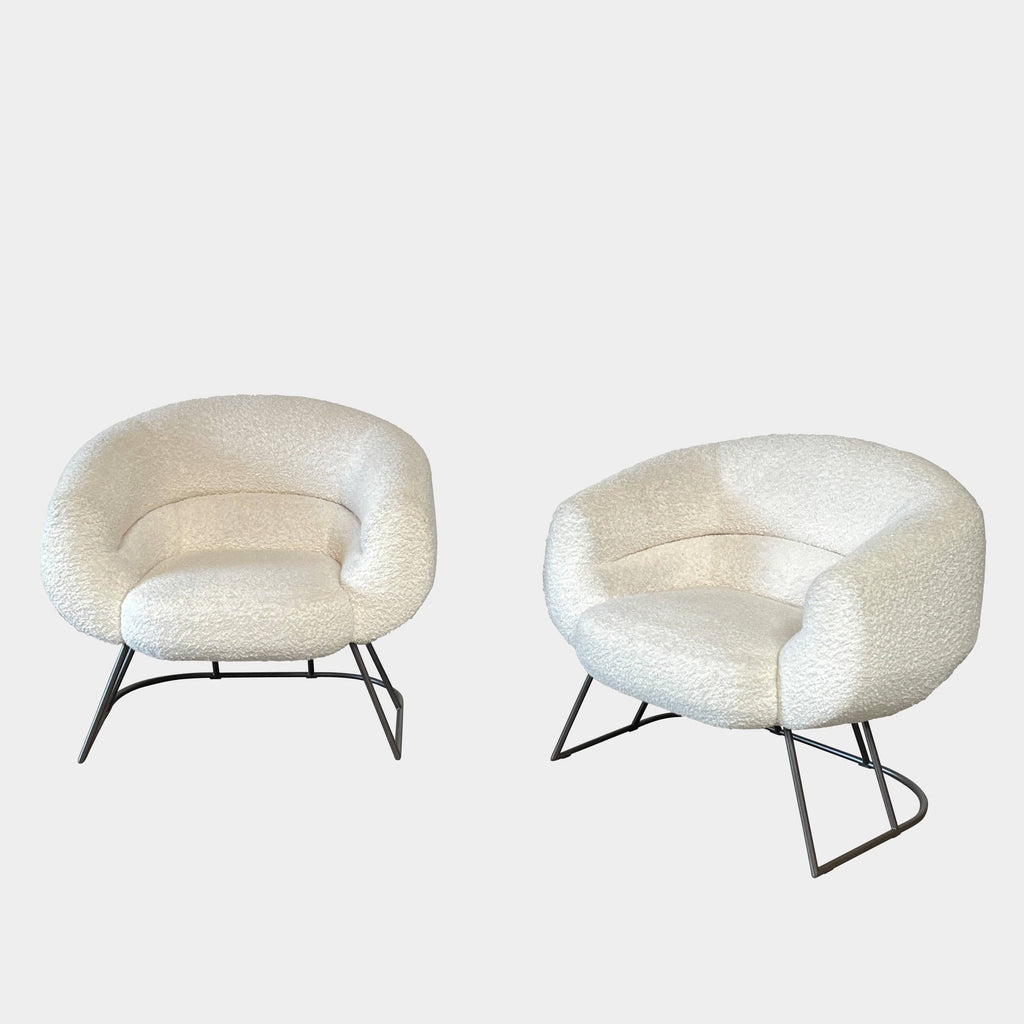 A pair of white Delcourt Collection DJE armchairs.