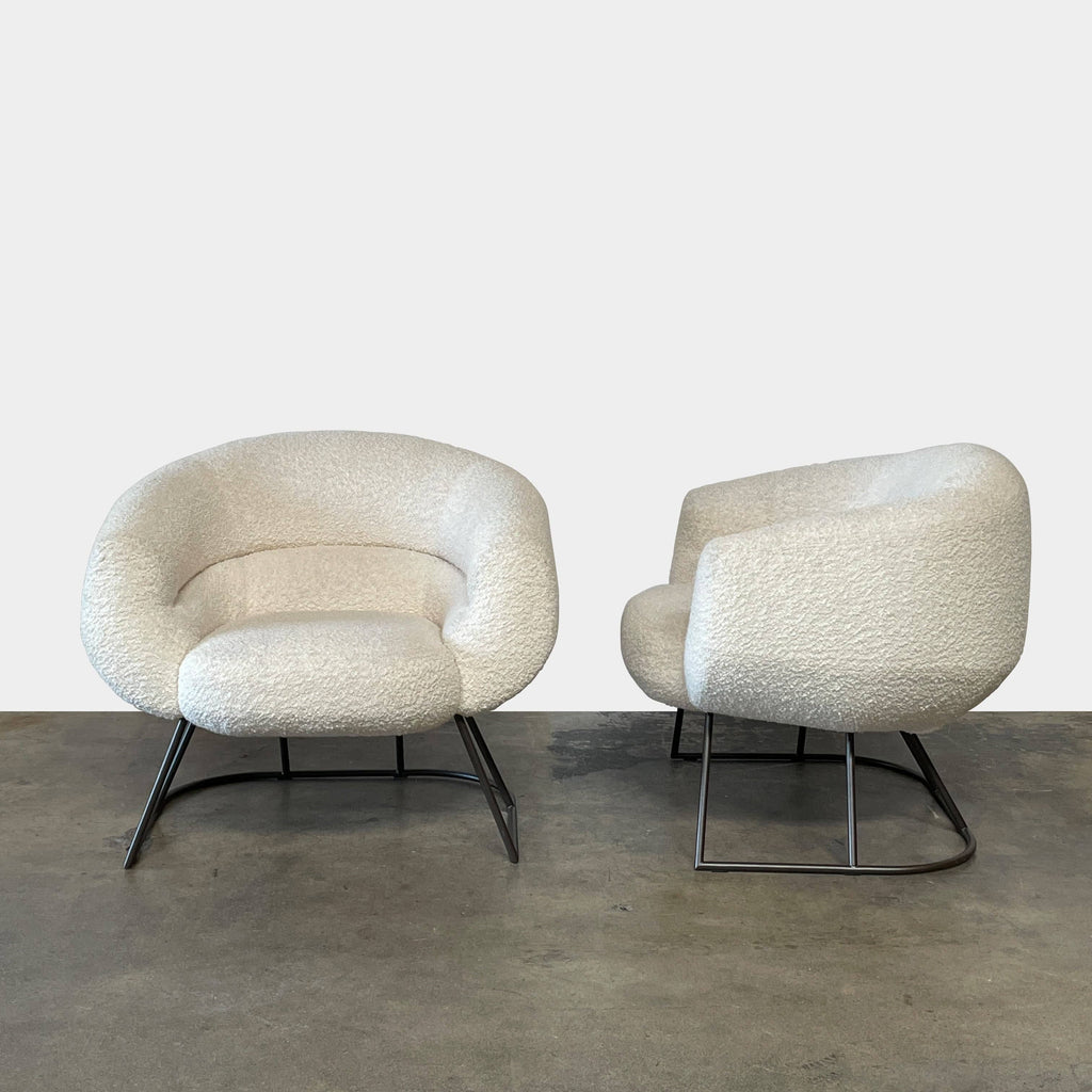 A pair of white Delcourt Collection DJE armchairs.