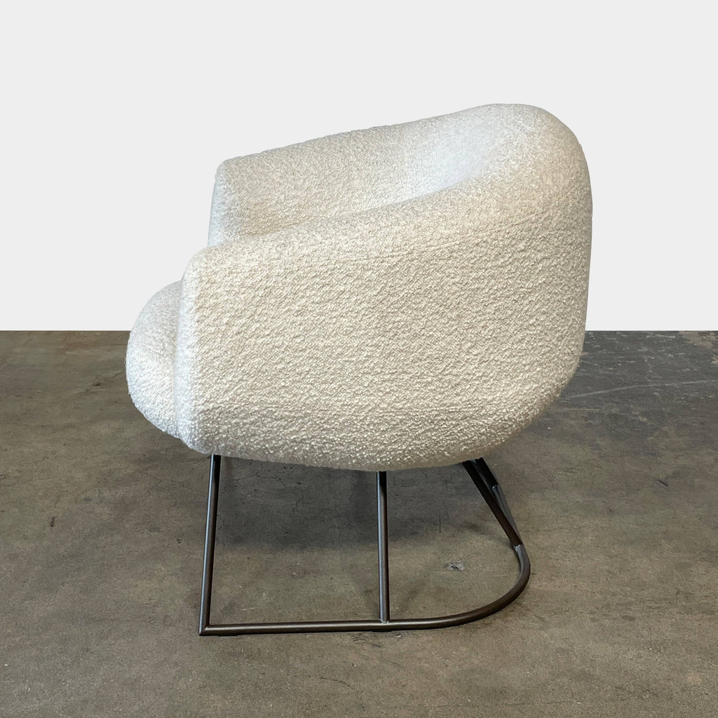 A pair of white Delcourt Collection DJE armchairs.