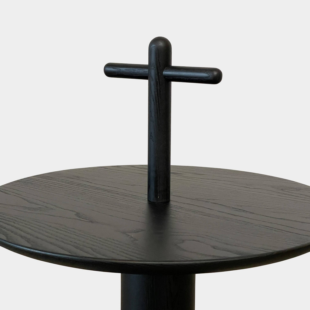 The Cassina Réaction Poétique Side Table logo is elegantly displayed on a sleek black surface.