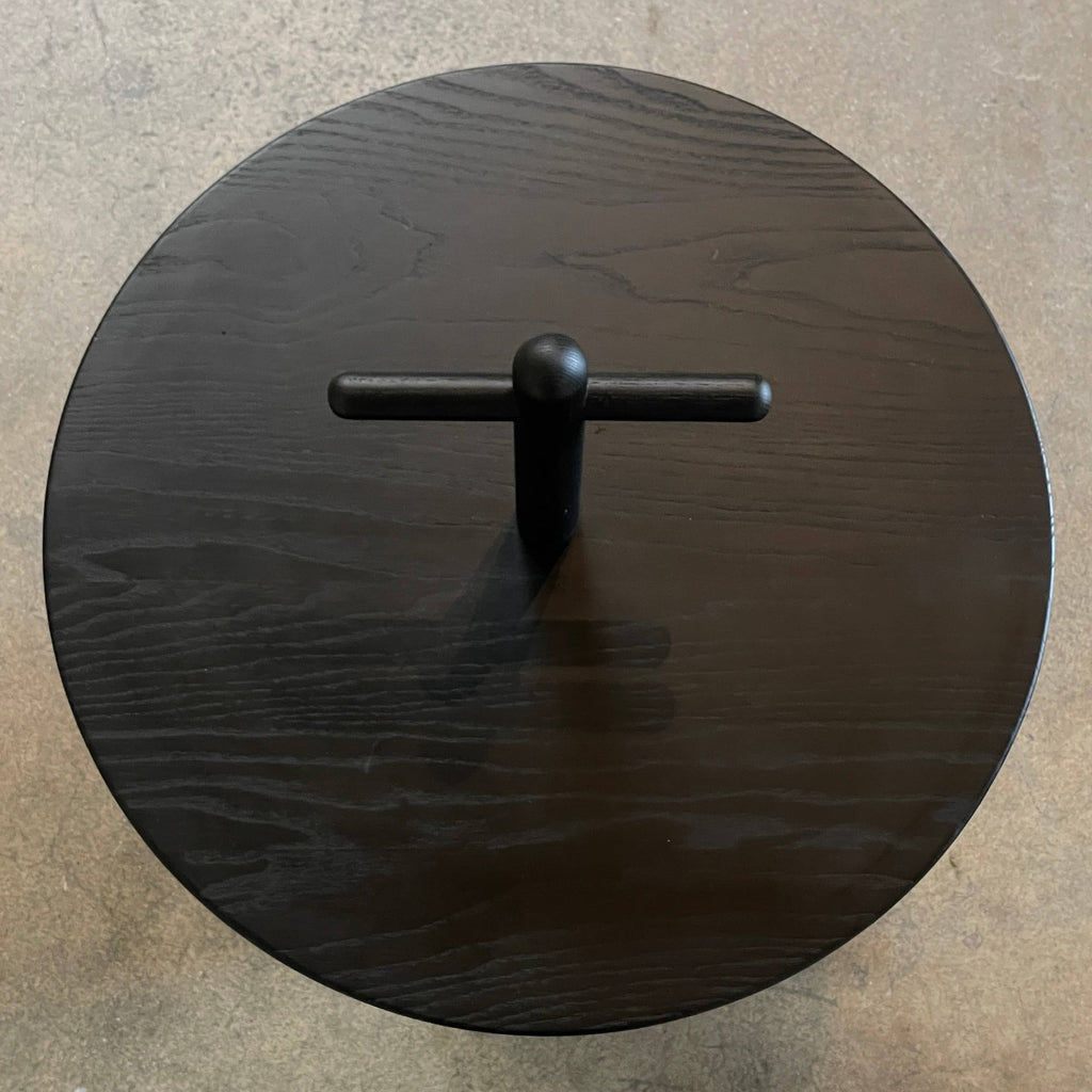 The Cassina Réaction Poétique Side Table logo is elegantly displayed on a sleek black surface.