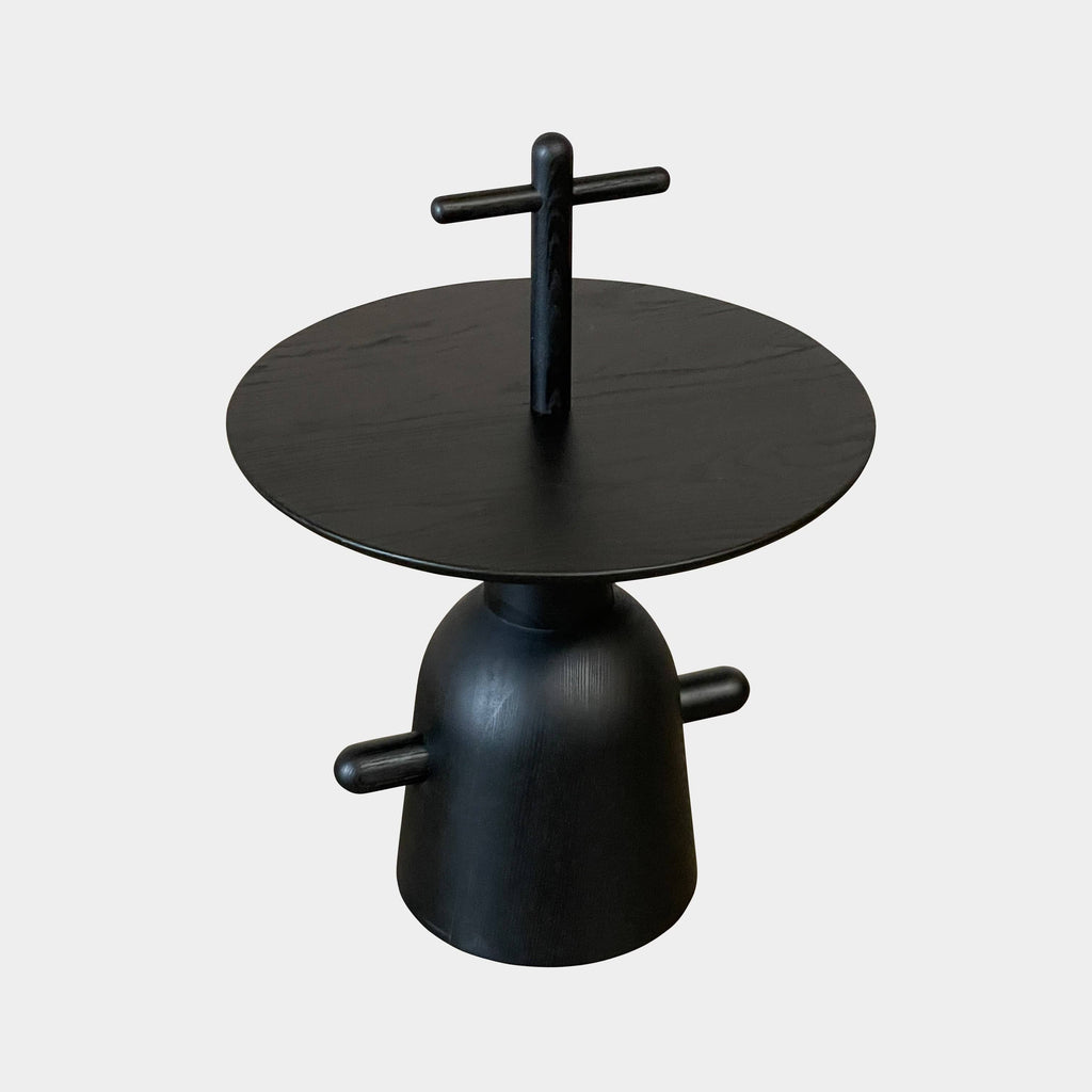 The Cassina Réaction Poétique Side Table logo is elegantly displayed on a sleek black surface.