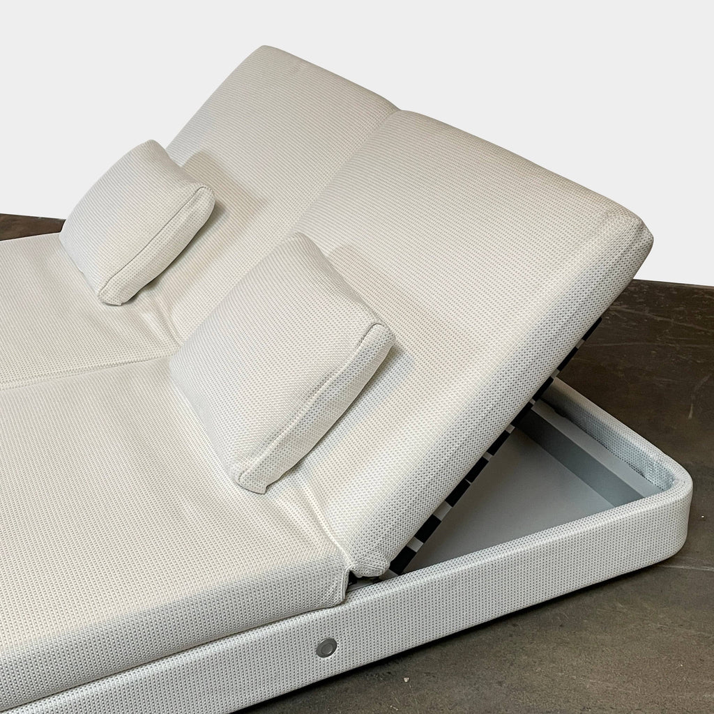 An adjustable white Paola Lenti Cove Double Sunbed by Paola Lenti features two separate reclining mattresses and matching pillows, perfect for outdoor lounging.