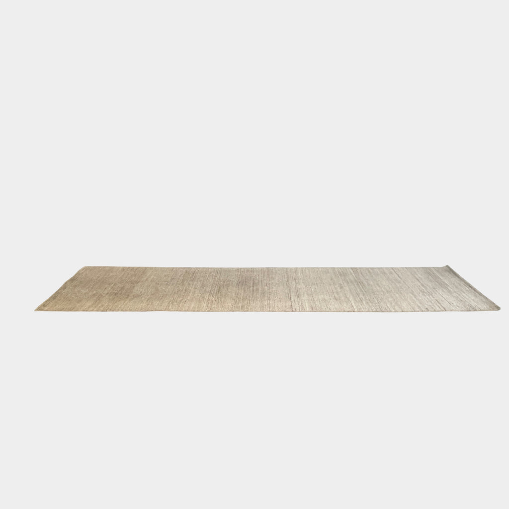 Three beige Delinear wool runners with dark borders on a concrete floor in a garage setting.