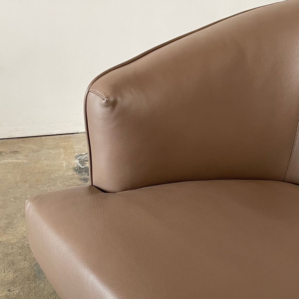 A Minotti Martin Brown Leather Swivel Chair with a cushioned seat and back, sitting on a sleek black chrome base, against a plain white background.