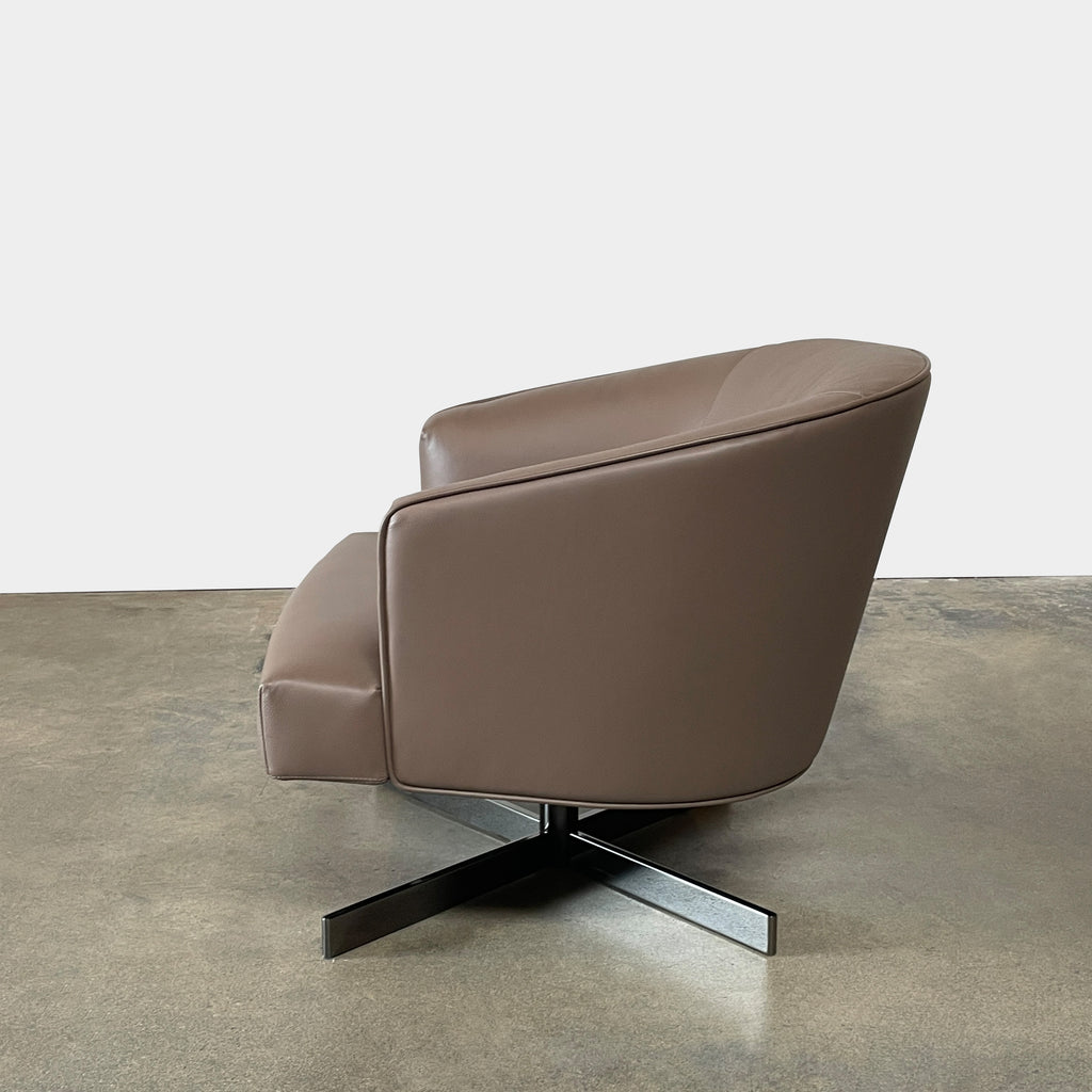 A Minotti Martin Brown Leather Swivel Chair with a cushioned seat and back, sitting on a sleek black chrome base, against a plain white background.