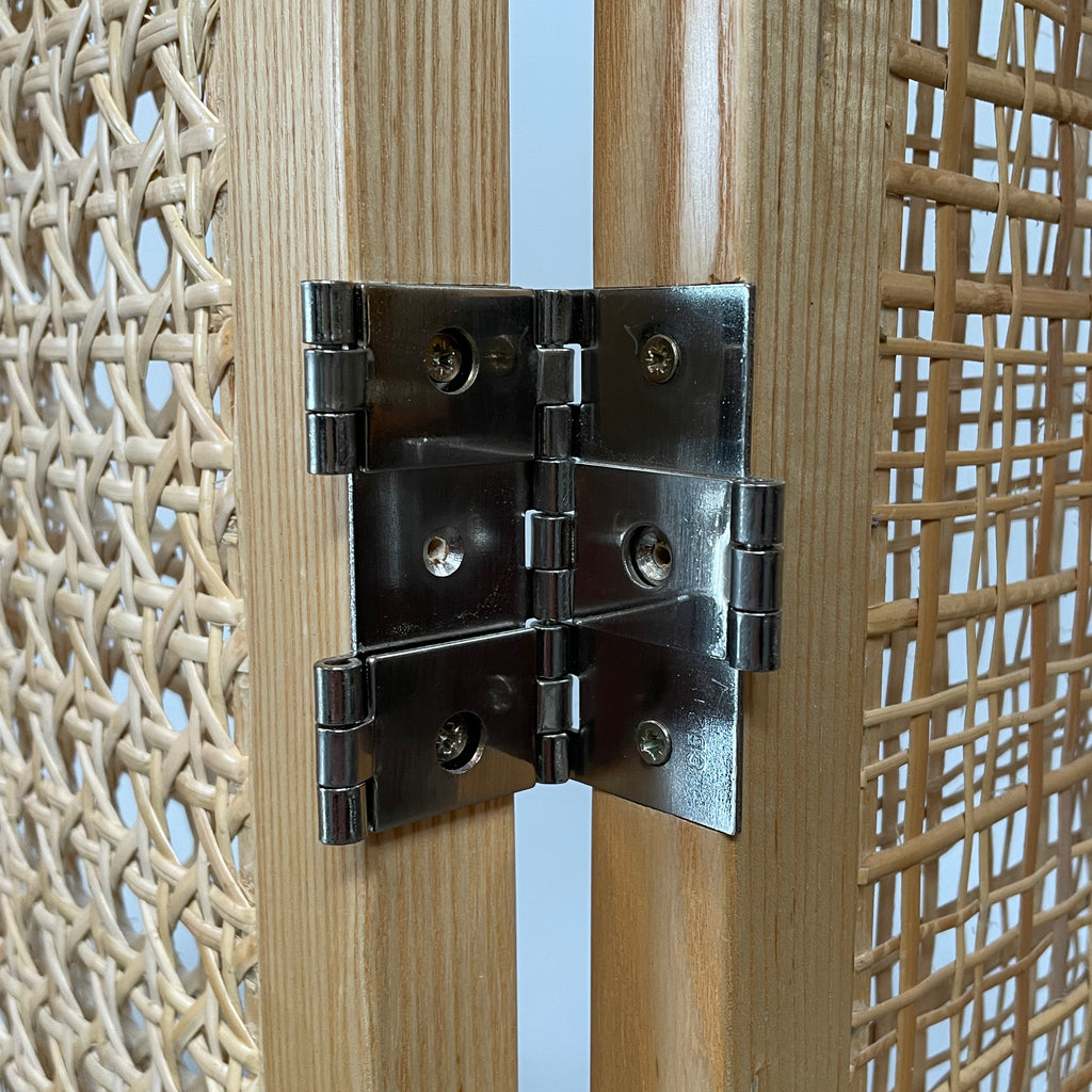 Close-up view of a wooden frame with a woven wicker panel, showcasing Lebanese craftsmanship. The wood shows a small patch of wear, offering a glimpse into the meticulous detailing associated with Nada Debs' contemporary Arabesque designs in the Nada Debs Summerland Folding Screen.