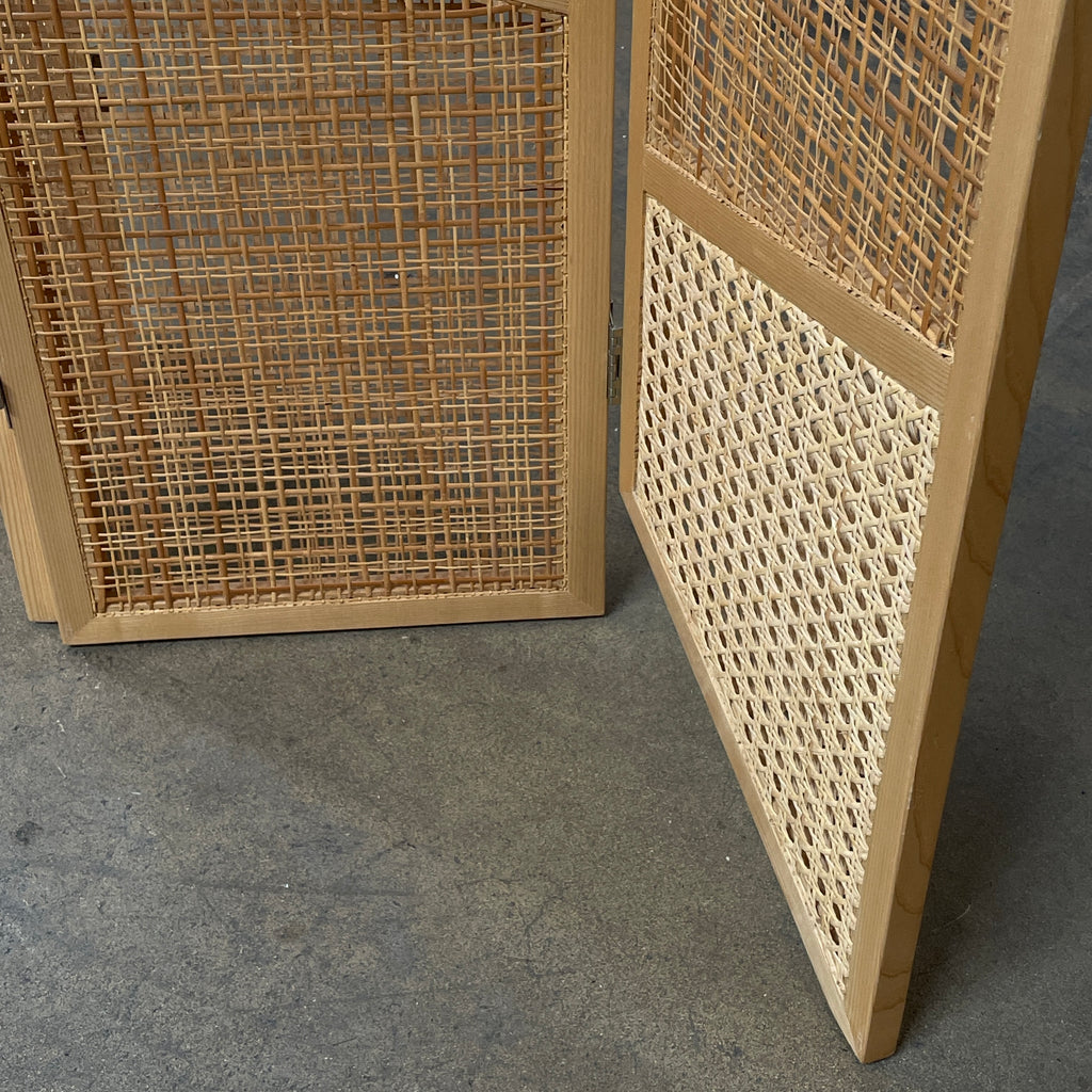 Close-up view of a wooden frame with a woven wicker panel, showcasing Lebanese craftsmanship. The wood shows a small patch of wear, offering a glimpse into the meticulous detailing associated with Nada Debs' contemporary Arabesque designs in the Nada Debs Summerland Folding Screen.