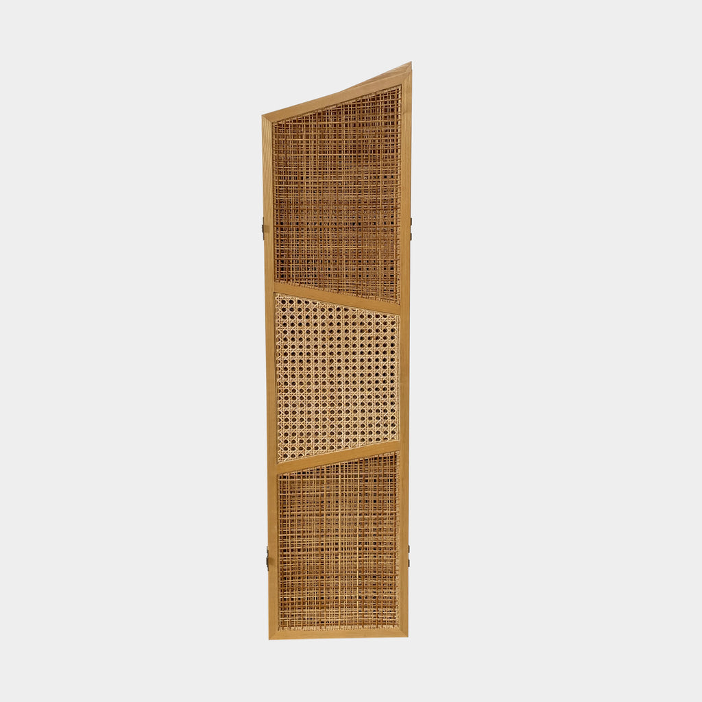 Close-up view of a wooden frame with a woven wicker panel, showcasing Lebanese craftsmanship. The wood shows a small patch of wear, offering a glimpse into the meticulous detailing associated with Nada Debs' contemporary Arabesque designs in the Nada Debs Summerland Folding Screen.