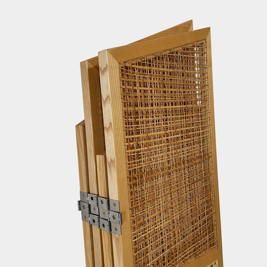 Close-up view of a wooden frame with a woven wicker panel, showcasing Lebanese craftsmanship. The wood shows a small patch of wear, offering a glimpse into the meticulous detailing associated with Nada Debs' contemporary Arabesque designs in the Nada Debs Summerland Folding Screen.