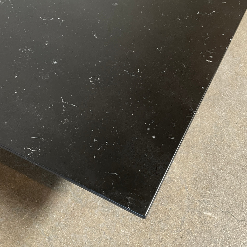 A minimalist rectangular black B&B Italia Diesis Coffee Table with metal legs, viewed directly from above, exudes timeless beauty against a plain white background.