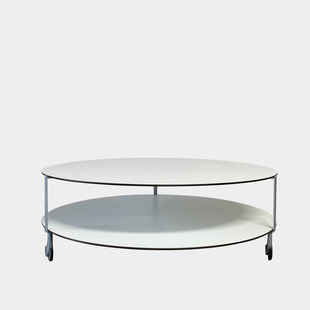 A Zanotta Giro Coffee Table, a round, white, two-tiered coffee table with a minimalist design, featuring a solid top and an open lower shelf for storage. The sleek steel frame adds durability, making it both stylish and functional.