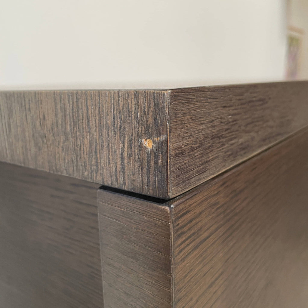 A Maxalto Mida High Cabinet featuring a brown wooden finish, two doors, and black metal legs stands elegantly against a white background.