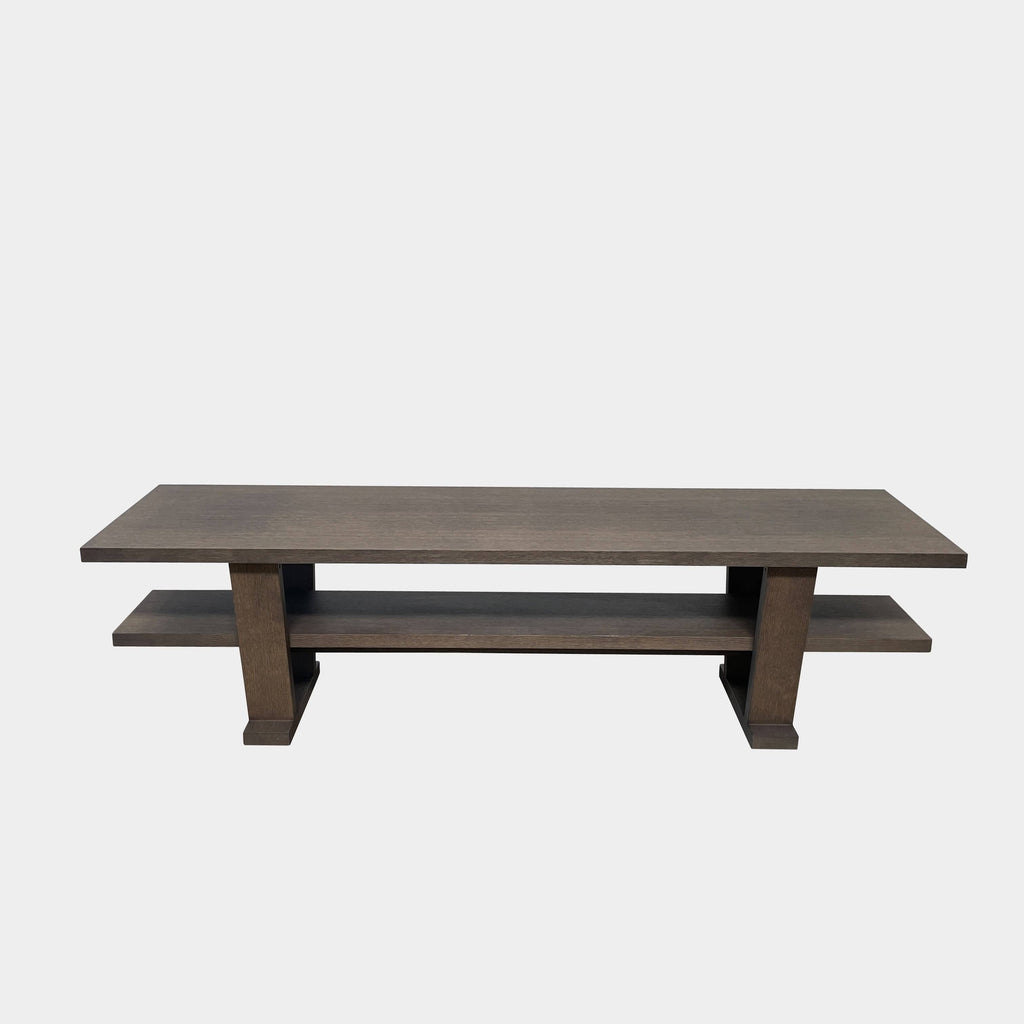 A wooden rectangular coffee table with a lower shelf and two supporting legs, reminiscent of a refined Maxalto Cicero Console by Maxalto.