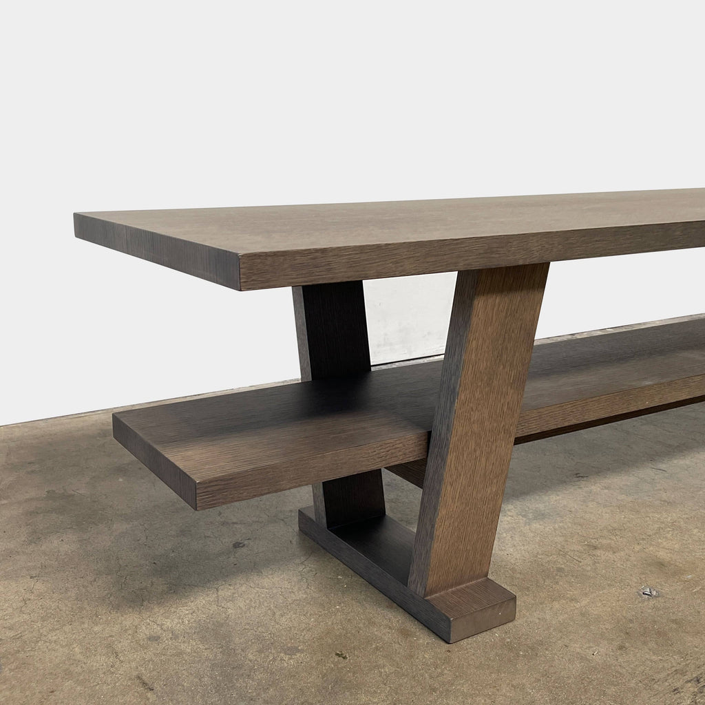 A wooden rectangular coffee table with a lower shelf and two supporting legs, reminiscent of a refined Maxalto Cicero Console by Maxalto.