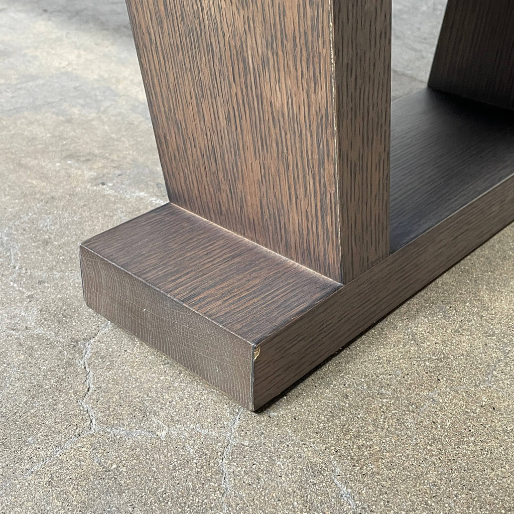 A wooden rectangular coffee table with a lower shelf and two supporting legs, reminiscent of a refined Maxalto Cicero Console by Maxalto.