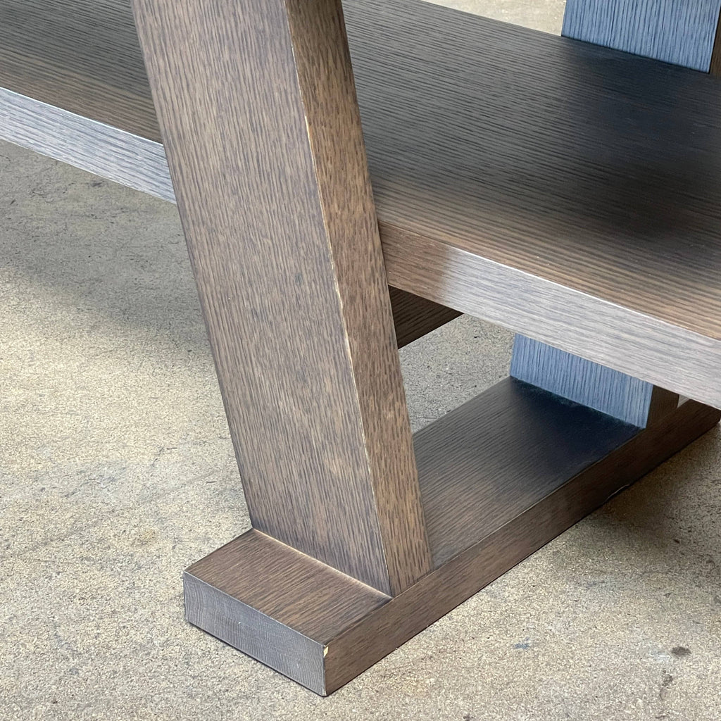 A wooden rectangular coffee table with a lower shelf and two supporting legs, reminiscent of a refined Maxalto Cicero Console by Maxalto.