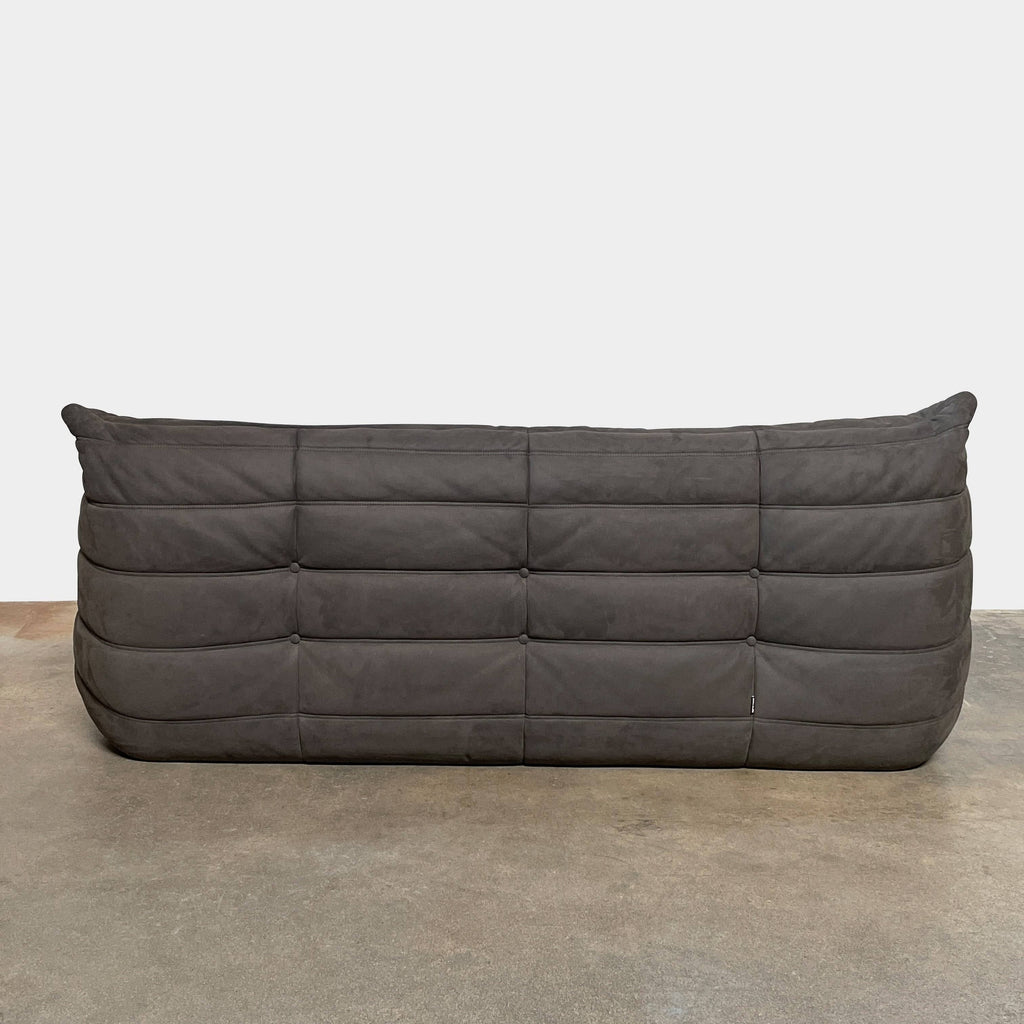 Ligne Roset Togo Three Piece Sectional, a black leather L-shaped sofa by Ligne Roset, features tufted cushions and a low backrest with polyether foam for enhanced comfort, beautifully displayed on a white background.