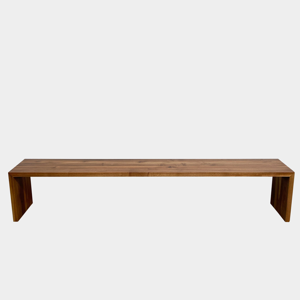 The Ligne Roset Eaton Bench is a long, rectangular wooden piece with a simple, minimalist design and angled legs at each end. Perfect as a 4-seater bench, it embodies the style and craftsmanship you'd expect from Ligne Roset.