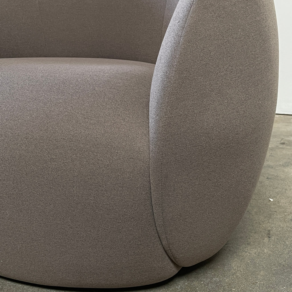 Two Roche Bobois Dot Chairs from the prestigious Roche Bobois brand, featuring a sleek grey and modern curved design, are positioned on a plain, light background. One chair faces forward while the other showcases its side profile, enhancing their sophisticated allure.