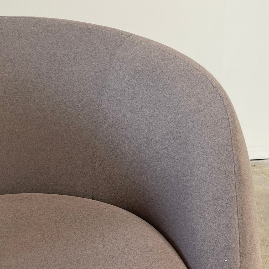 Two Roche Bobois Dot Chairs from the prestigious Roche Bobois brand, featuring a sleek grey and modern curved design, are positioned on a plain, light background. One chair faces forward while the other showcases its side profile, enhancing their sophisticated allure.