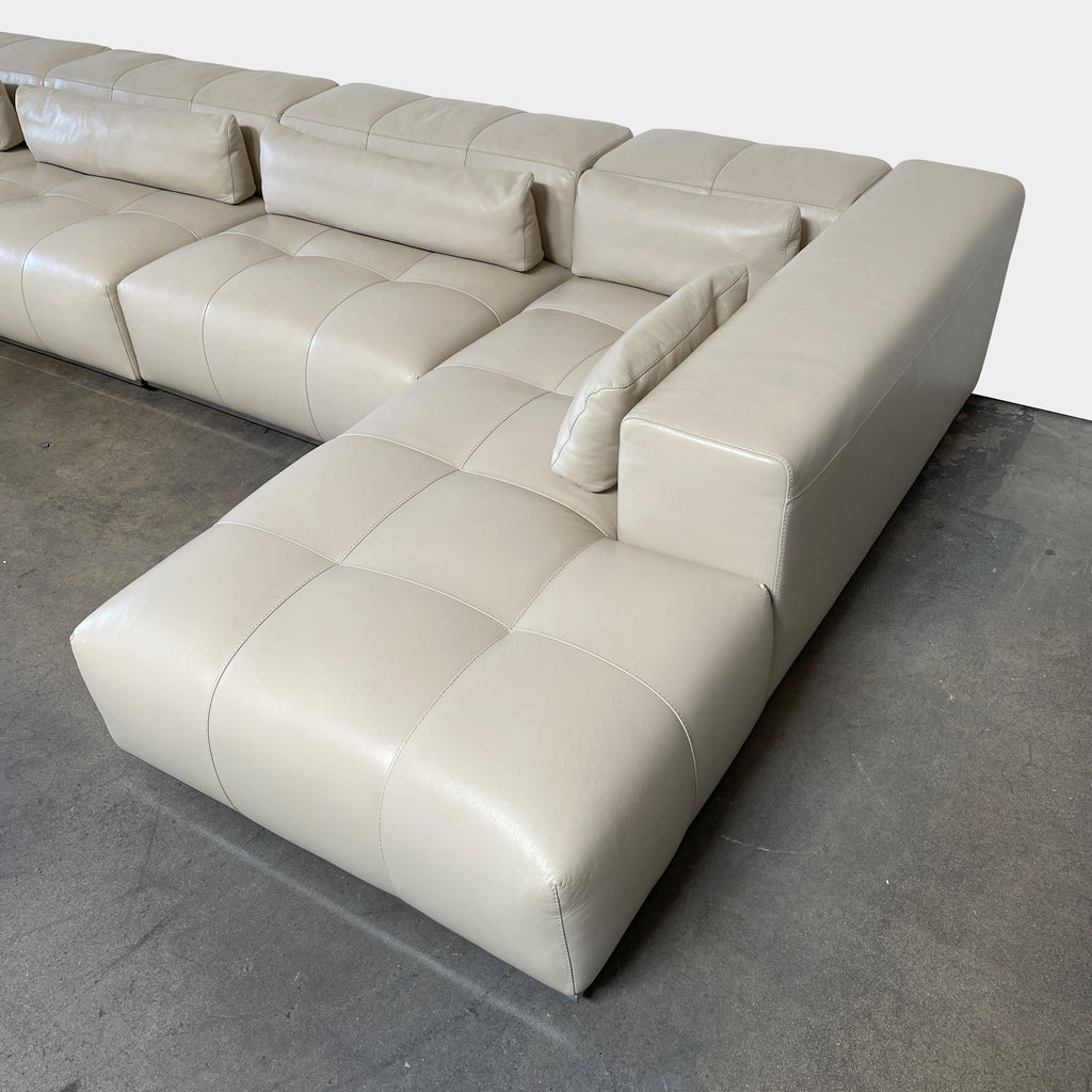 A large beige L-shaped Functions Nick Sectional sofa from the Functions brand, featuring cushioned seats and backs, is viewed against a plain white background.