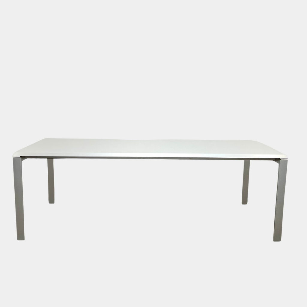 The Pallucco Italia Little Wing Dining Table, crafted with the elegance of Italian manufacturing and the design genius of Carlo Tamborini, boasts a minimalist white rectangular surface paired with slender metal legs.