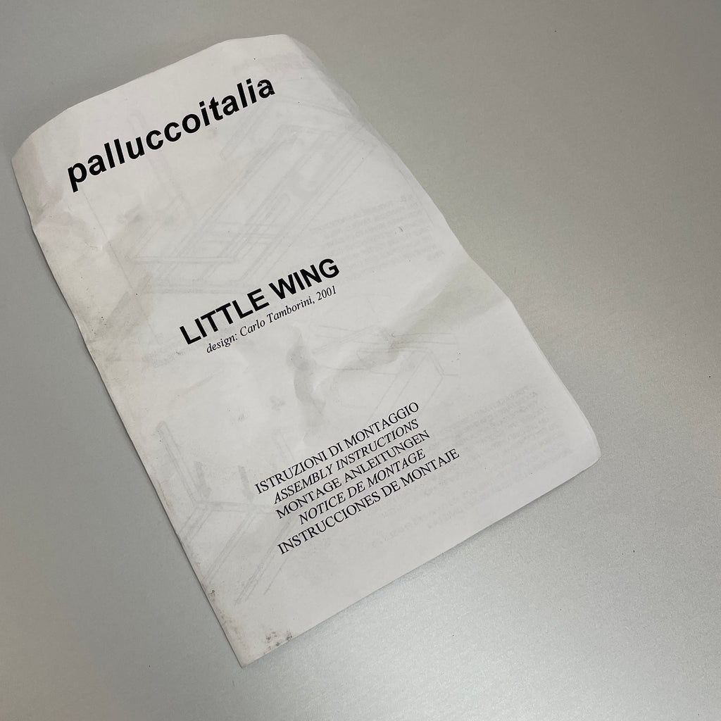 The Pallucco Italia Little Wing Dining Table, crafted with the elegance of Italian manufacturing and the design genius of Carlo Tamborini, boasts a minimalist white rectangular surface paired with slender metal legs.