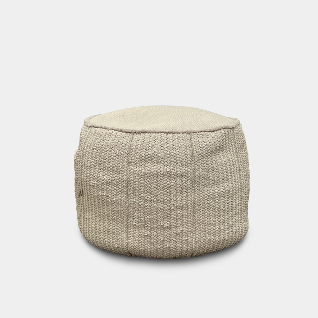 The Paola Lenti Play Outdoor Pouf, in beige, provides a cozy extra seating option for any room against a white background.