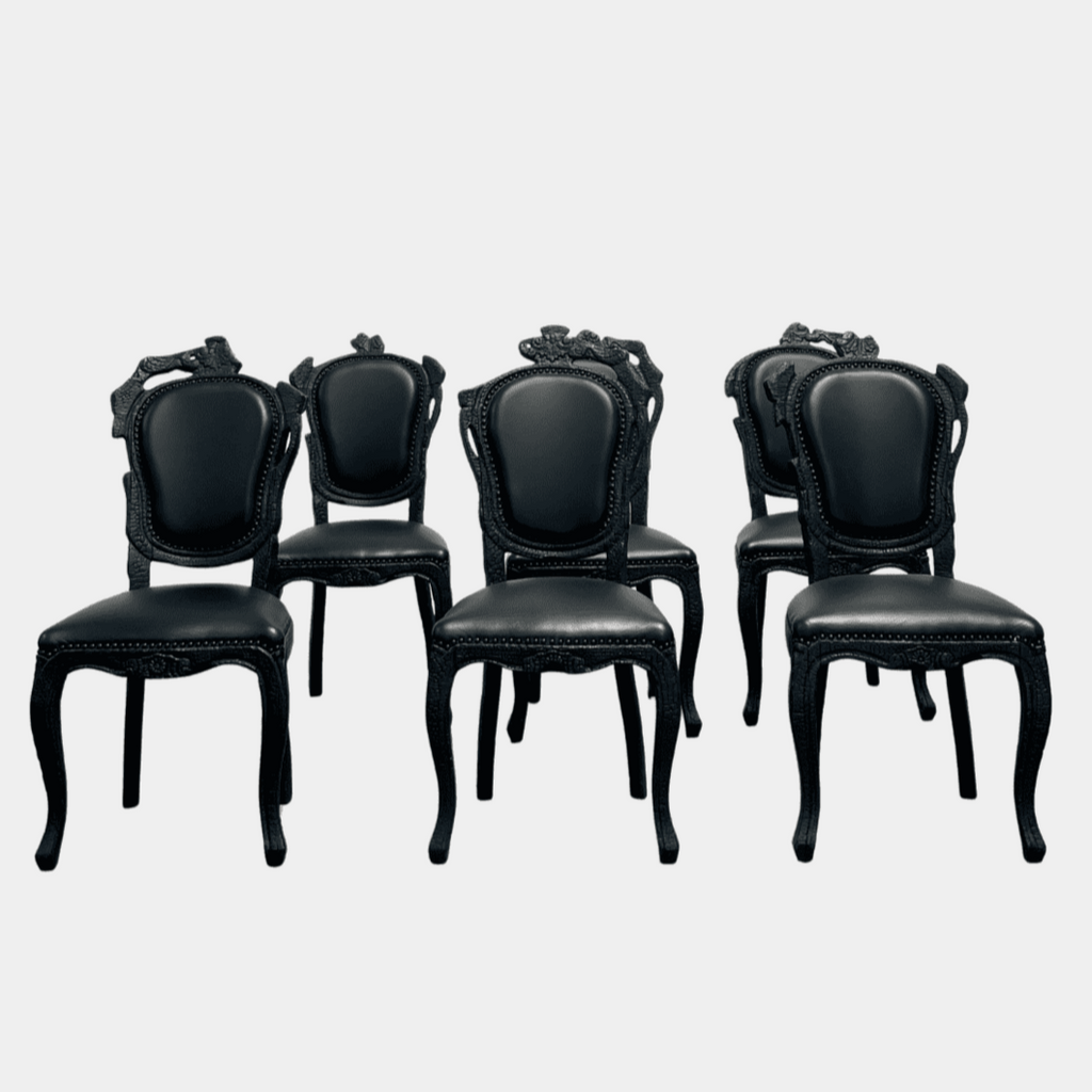 A set of seven Moooi Smoke Dining Side Chairs, crafted by Moooi in an ornate black finish with leather upholstery and cushioned seats and backs, arranged in two rows against a plain white background.