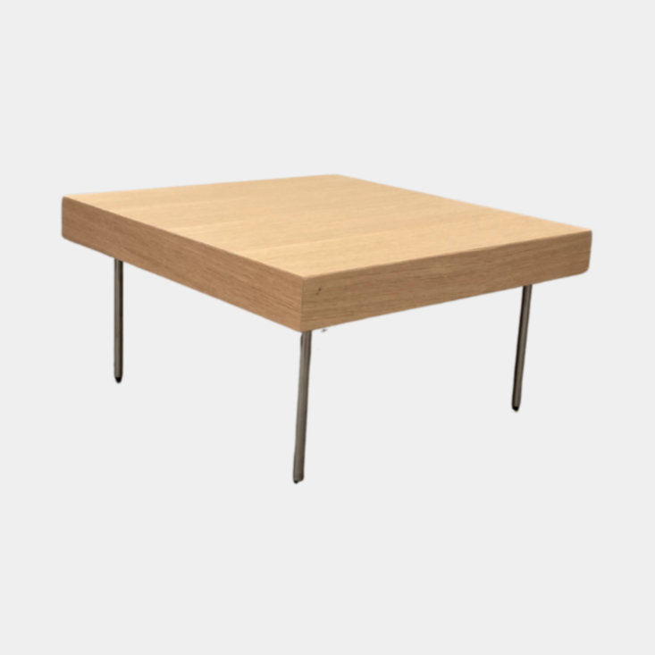 Ligne Roset Natural Wood Needle Table with metal legs on a plain white background, showcasing an elegant natural design.