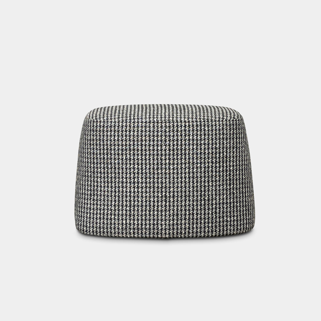 The B&B Italia Frank Oval Ottoman boasts a striking black and white houndstooth pattern on a pristine white background.