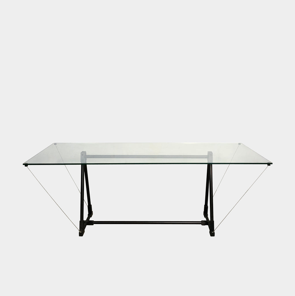 A Fontana Arte Multi-Functional table with a glass top and black legs.
